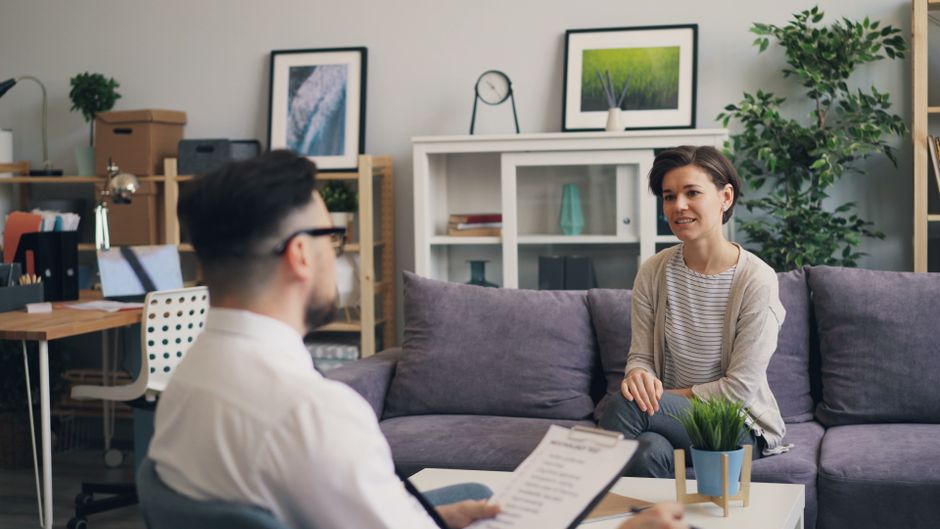 A therapist and client in a modern, relaxing office setting.